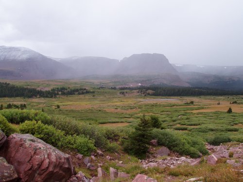 Looking back at Henry's Fork Basin from Gunsight Pass. There is snow falling on the far end of the Basin.